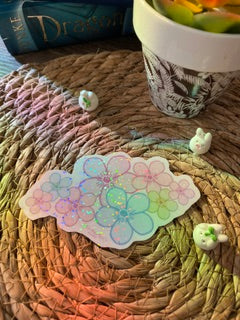 Brighten your gear with our hand-cut rainbow holographic cherry blossom sticker. This 4x2.25 inch pastel sakura cluster decal is waterproof, laminated, and perfect for laptops.